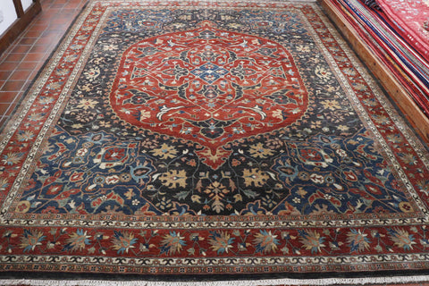 A very handsome looking carpet with a traditional oval central medallion. The colouring is fairly unusual with a terracotta colour for the medallion and main border and the background colour is a charcoal grey with slate blue in the corner sections. Other colour incorporated are pale gold, peach, cream and soft green. The construction is a soft wool pile on to a cotton foundation.