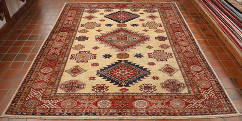 Cream central ground with three large medallions.  The central one predominantly red and green, the two at either end dark blue and red.  There are a series of borders of differing widths and decorative styles.  These are decorated using the same colour palette. 